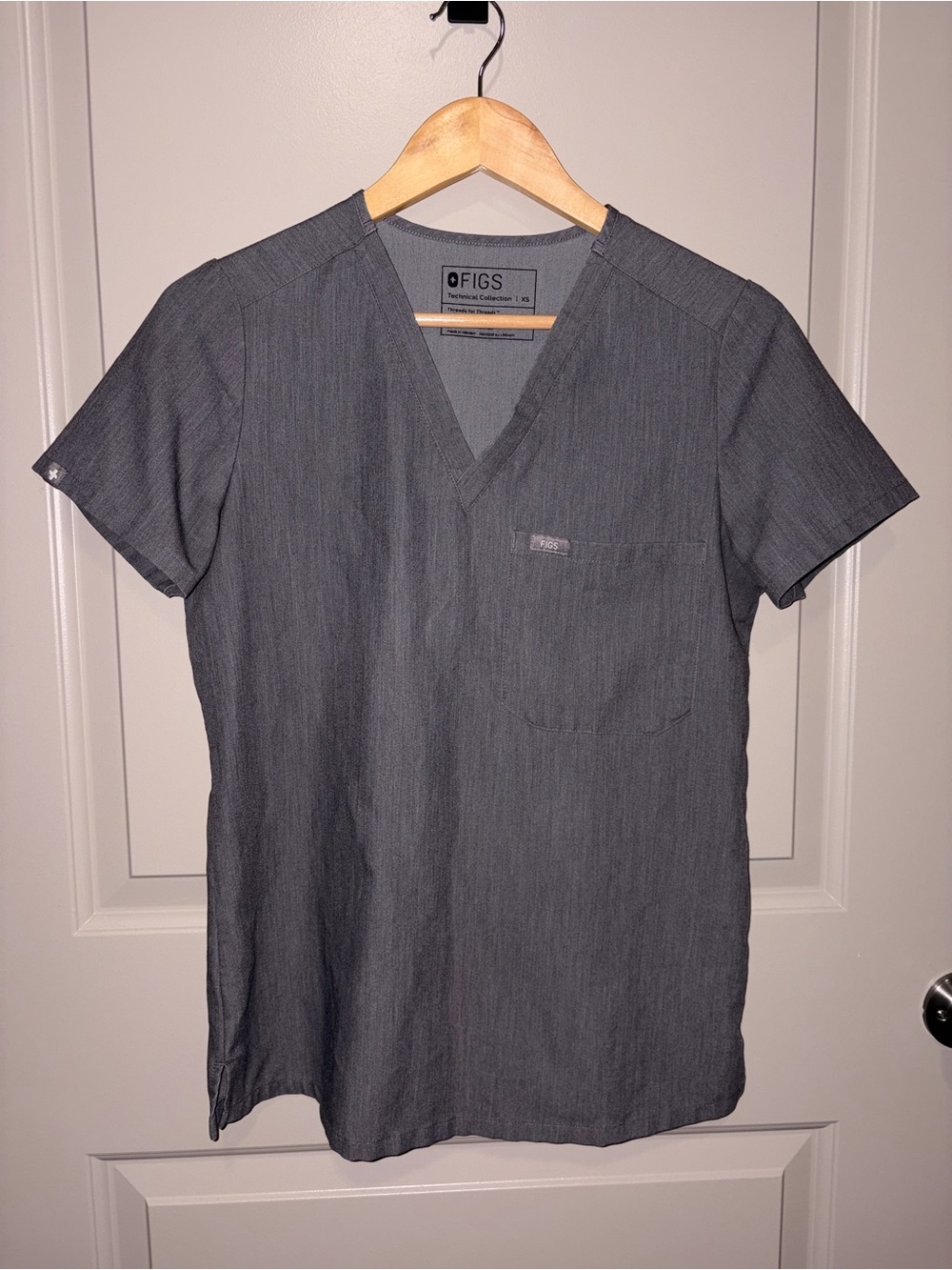 FIGS Women’s Catarina Scrub Top in color Graphite